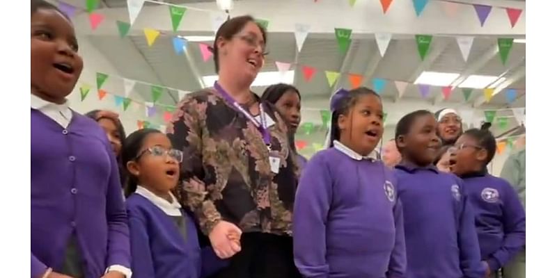 Sweet moment King Charles is treated to rendition of 'Happy Birthday' by schoolchildren at Coronation Food Hub visit - before traditional gun salutes ring out across Britain