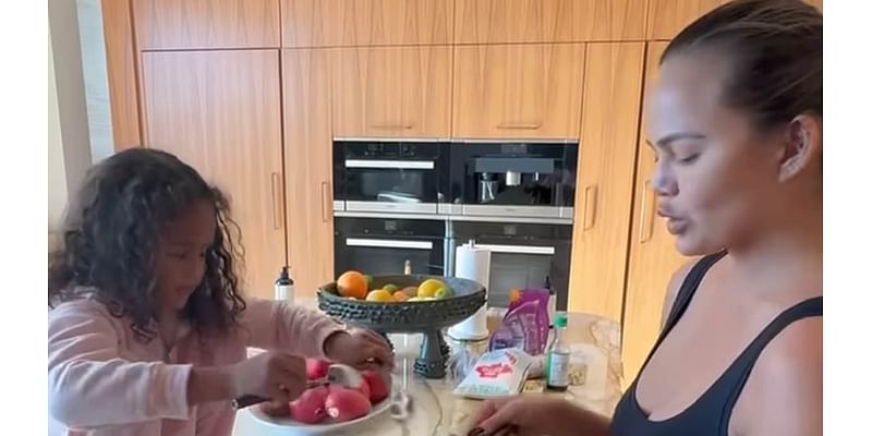 Chrissy Teigen called out for letting daughter put her bare feet on kitchen counter while they cook