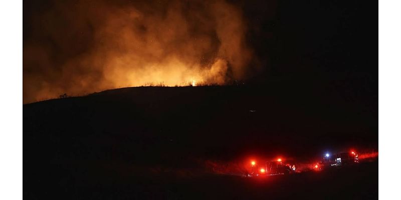 Fire burns hillside along Highway 101 in Pismo Beach