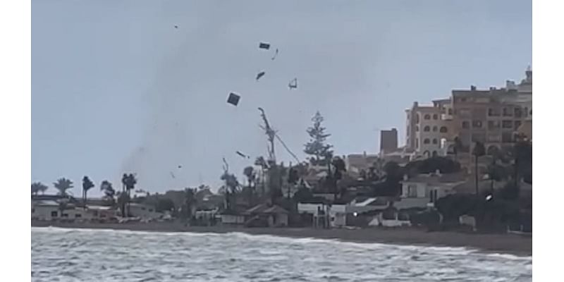 Shocking moment tornado sends debris flying on Malaga beach as footage shows the Costa del Sol hit by water spouts, floods and torrential rain in latest storms to hit Spain