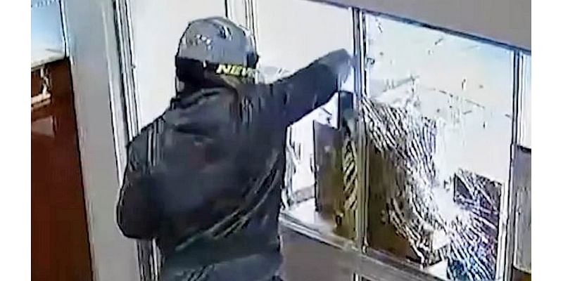 Moment armed robbers stage terrifying £130k daylight jewellery store raid - as police admit one is still on the run