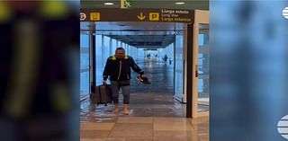 Passengers wade through flood waters inside airport