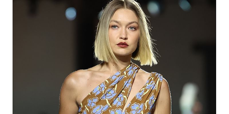 Gigi Hadid storms the Versace runway in an asymmetrical floral dress as she joins Vittoria Ceretti and Iris Law on the catwalk at Milan Fashion Week