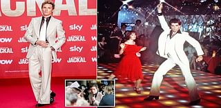 Eddie Redmayne resembles John Travolta in Saturday Night Fever as actors pulls on a white flared suit for the Berlin premiere of The Day Of The Jackal