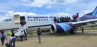 Moment flames shoot from the engine of a Boeing jet before take-off forcing terrified passengers to jump from emergency exits