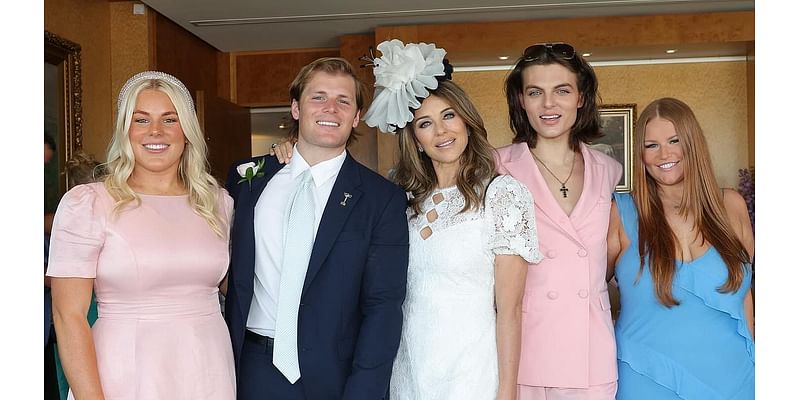 Elizabeth Hurley tenderly wraps her arm around ex Shane Warne's daughter Brooke as she reunites with the late cricketers children at Crown Oaks Day in Melbourne