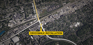 Crews installing crosswalk at West Walnut St & University Pkwy