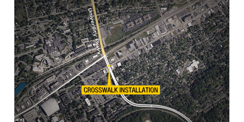 Crews installing crosswalk at West Walnut St & University Pkwy