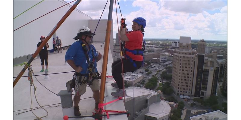 Dozens of people rappel down 20-story San Antonio hotel in effort to raise money for local literacy programs