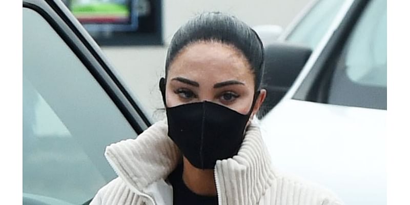 Tulisa hides her face behind surgical mask after revealing the shocking results of swollen TATTOOED lips ahead of I'm A Celeb stint