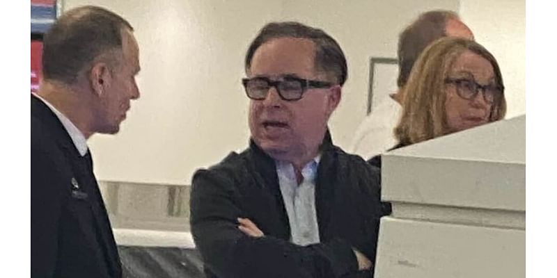 Alan Joyce is forced to wait for his baggage at an airport carousel like everyone else - after losing $9million bonus for trashing Qantas' reputation