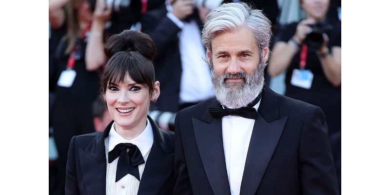 Winona Ryder and Partner Scott Mackinlay Hahn Hold Hands on Red Carpet at Venice Premiere of Beetlejuice 2