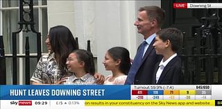 Moment outgoing Chancellor Jeremy Hunt leaves Downing Street with his wife and children after Tories lose election (but he manages to cling onto his Surrey safe seat)
