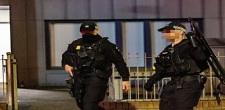 Heavily armed police involved in overnight manhunt after double stabbing at Belfast bar