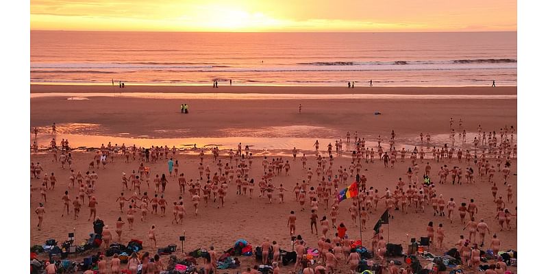 Nude awakening! 1,200 brave skinny dippers dash into the freezing North Sea for charity