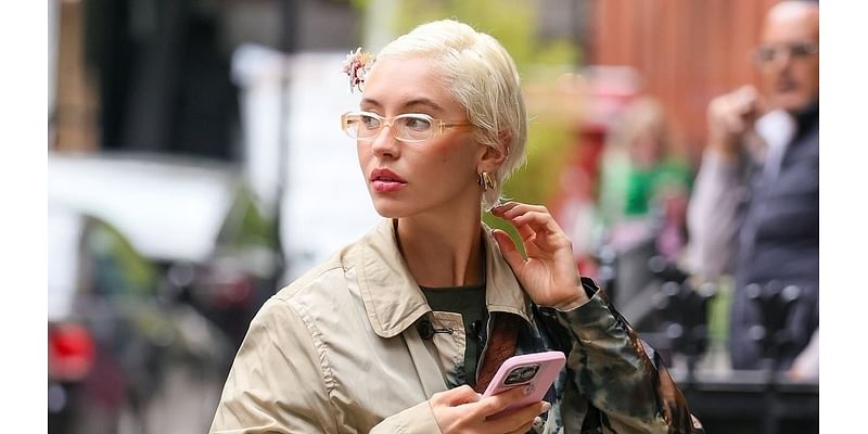 Iris Law cuts a stylish figure in a tie-dye trench coat and glasses as she arrives at London studio for mystery project